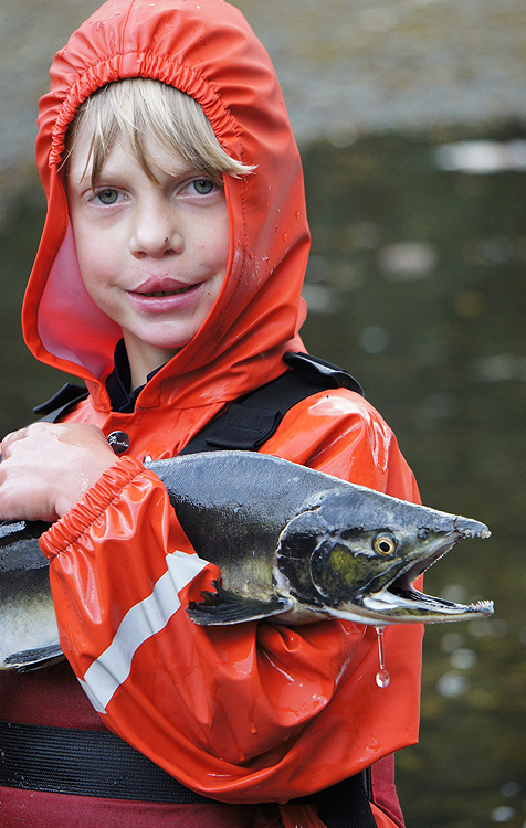 Child with Salmon on an Alaska Family Vacation Cruise